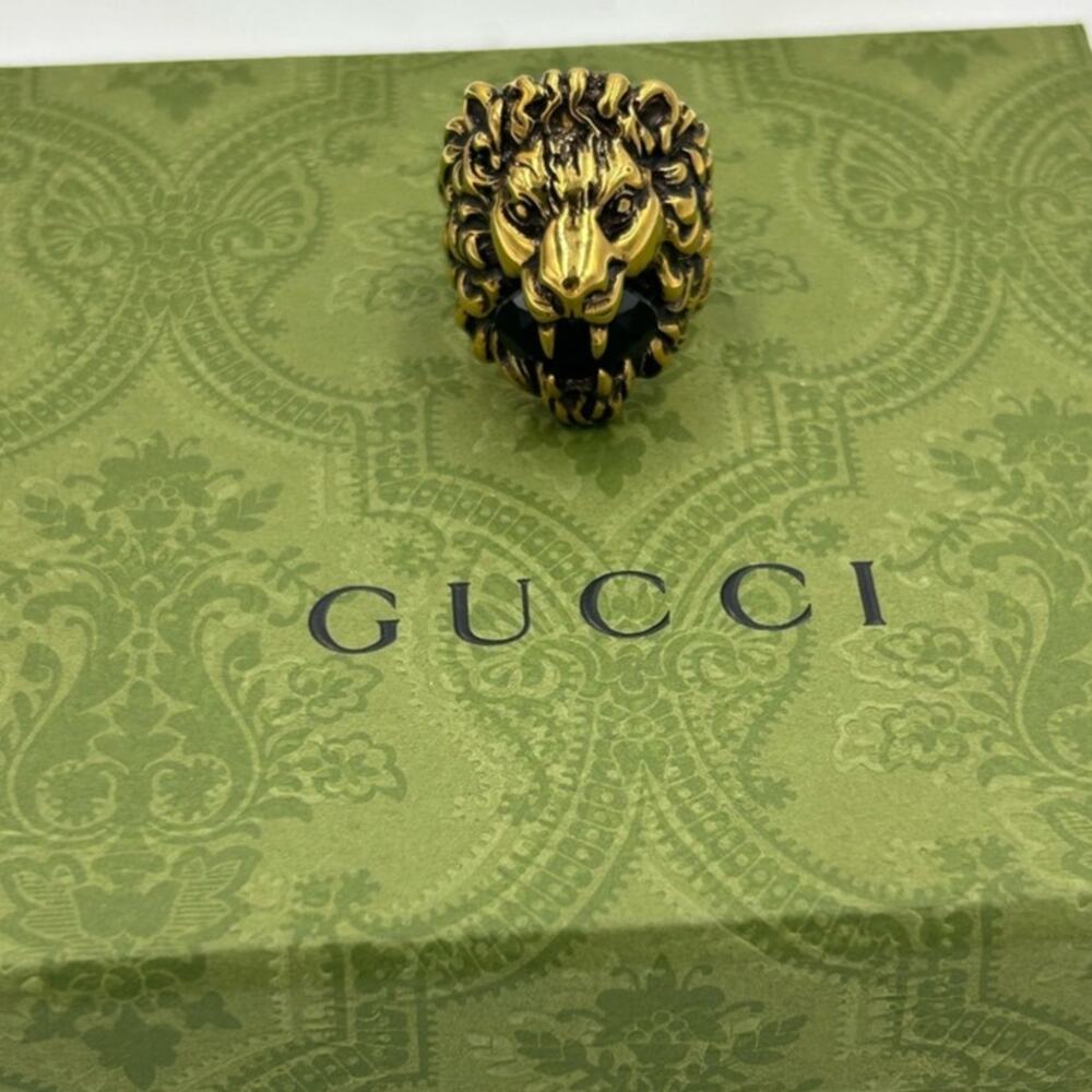 Unisex Gucci, Lionhead ring in aged gold tone, metal with black crystal size 10